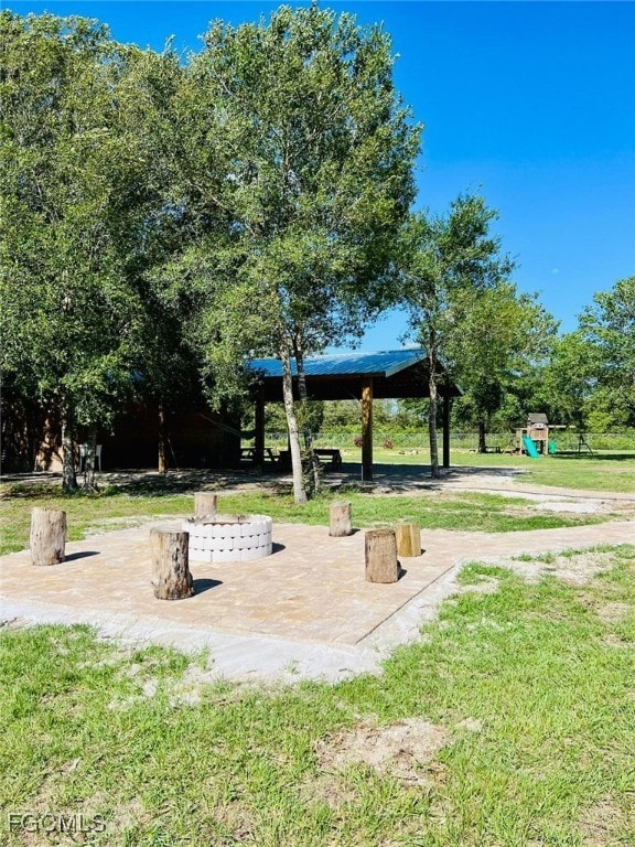 View of property's community featuring a patio area and a yard