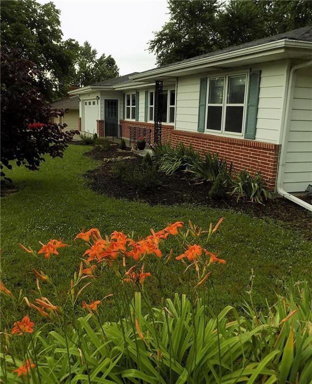 Day-lily, iris, & lilac highlight the yard.