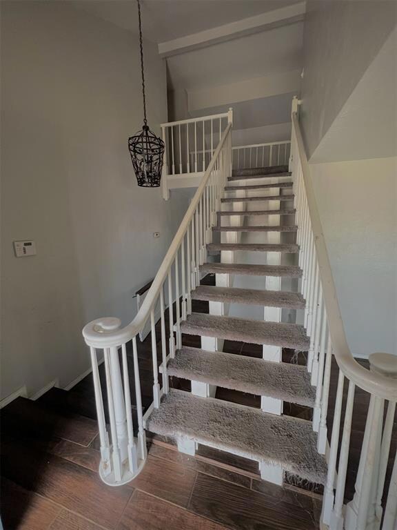 Stairs featuring dark hardwood / wood-style floori