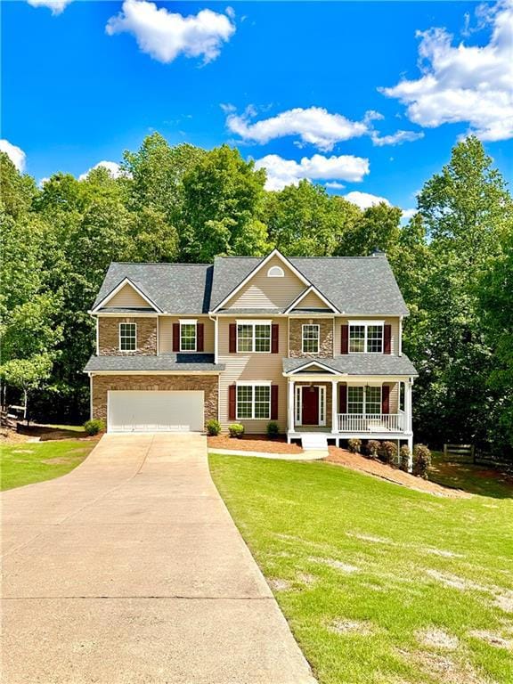 Colonial home featuring covered porch, an attached