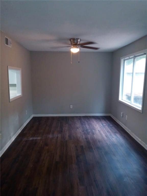 Unfurnished room with dark wood-type flooring and 