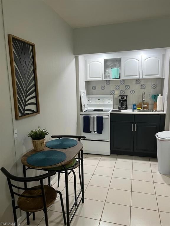 Kitchen featuring white range with electric cookto