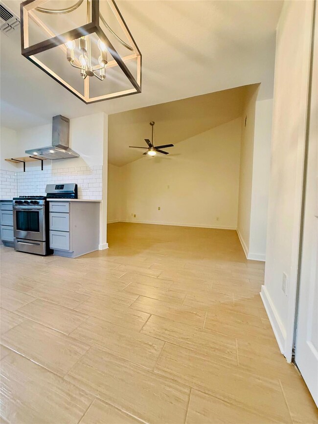 Kitchen featuring visible vents, ceiling fan with