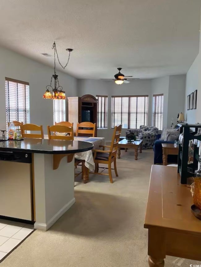 Kitchen featuring ceiling fan with notable chandel