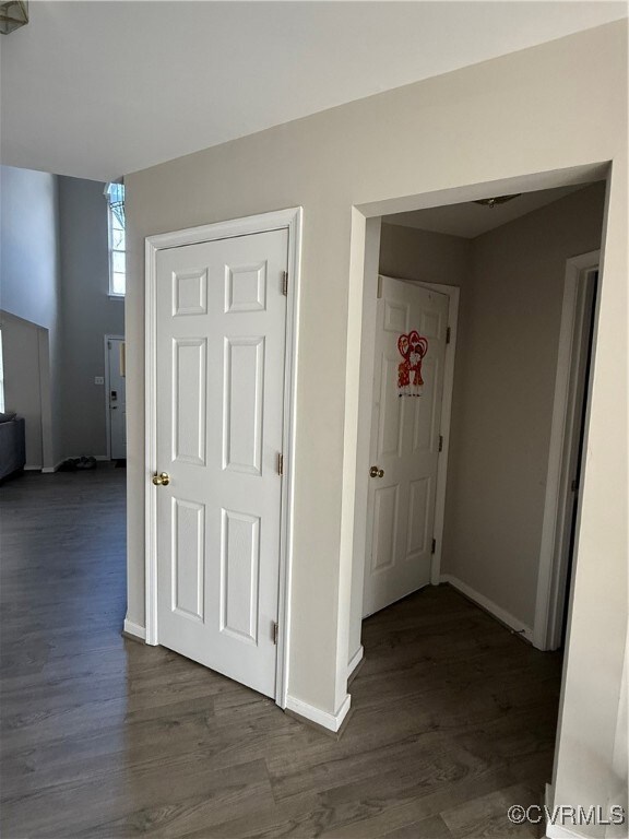 Hallway featuring dark wood-type flooring