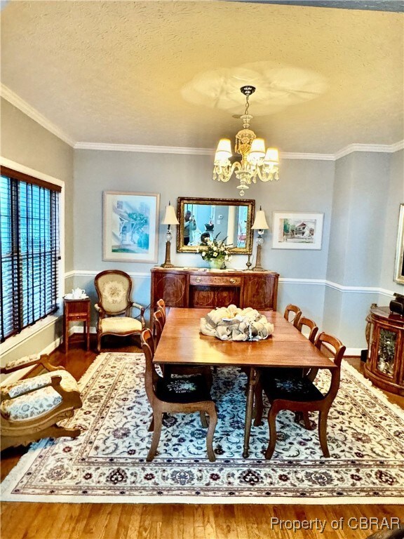 Dining area with an inviting chandelier, hardwood