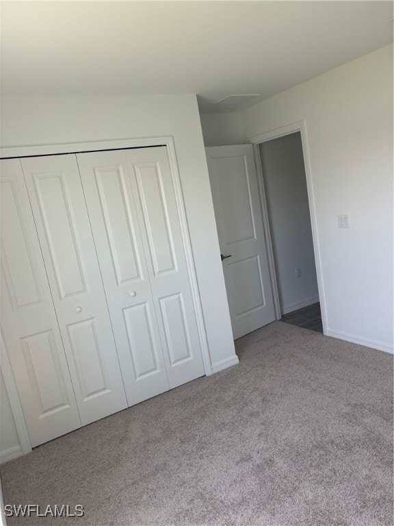 Unfurnished bedroom featuring carpet floors, a clo