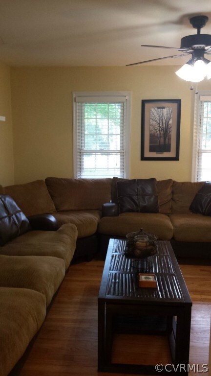 Spacious living room with hardwood floors, ceiling