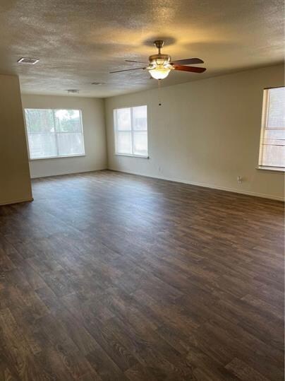 Unfurnished room featuring dark wood finished flo