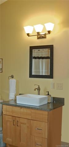 Bathroom is between the two bedrooms and a small hall.