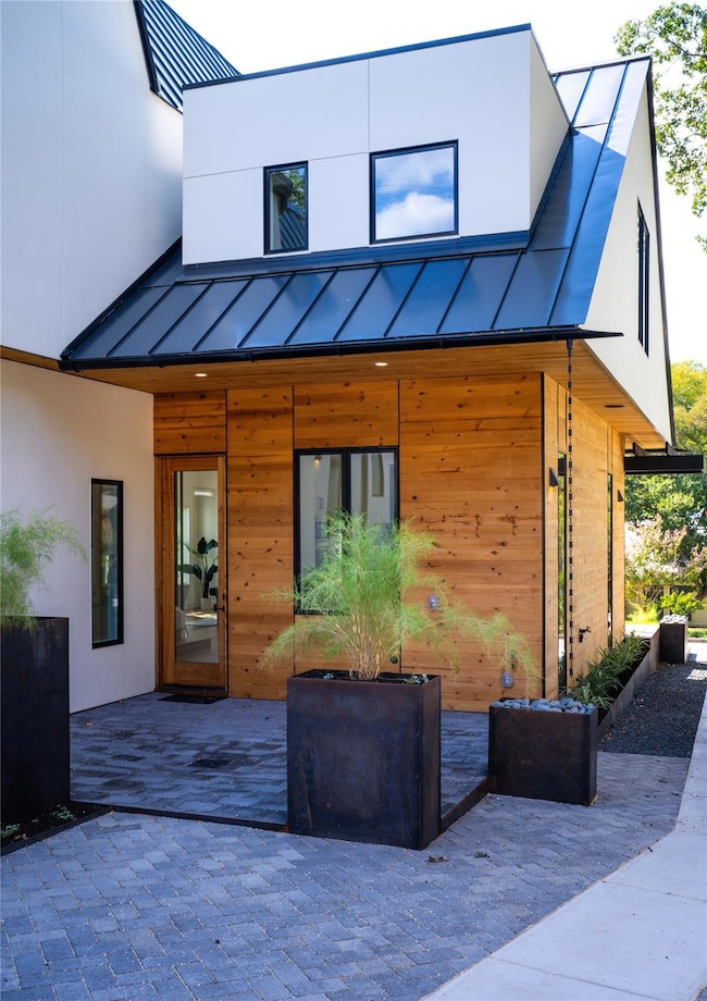Rear view of house with a standing seam roof, met