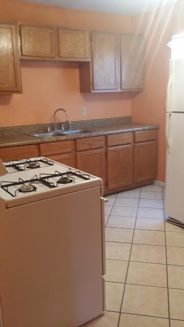 Remodeled kitchen with nice tile floor.