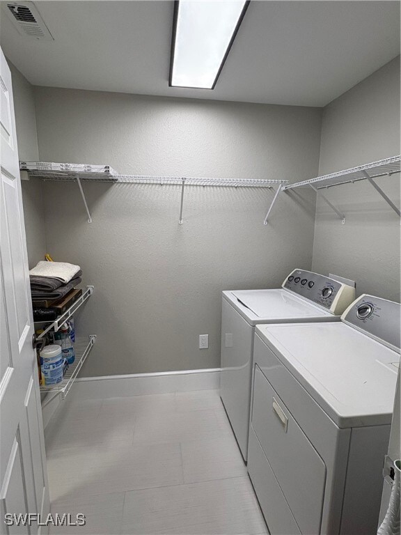 Laundry area featuring baseboards and washer and dryer