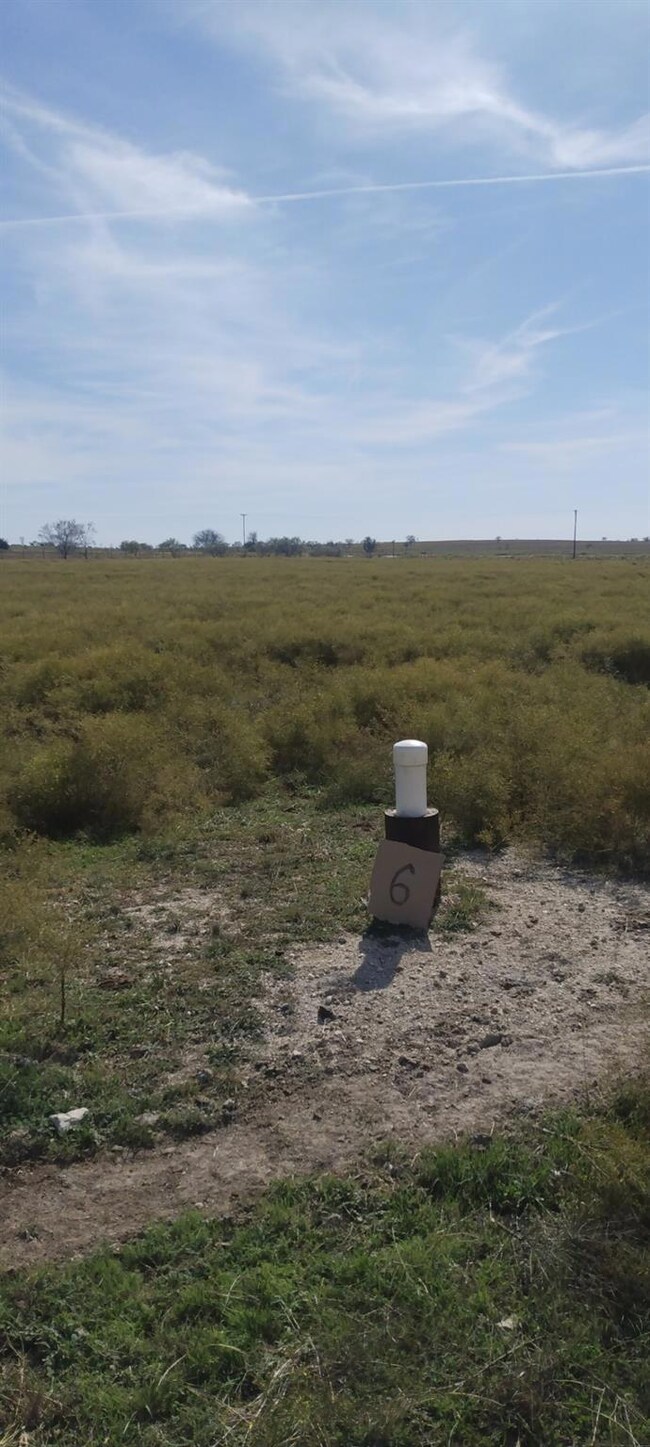 View of storm shelter with a rural view