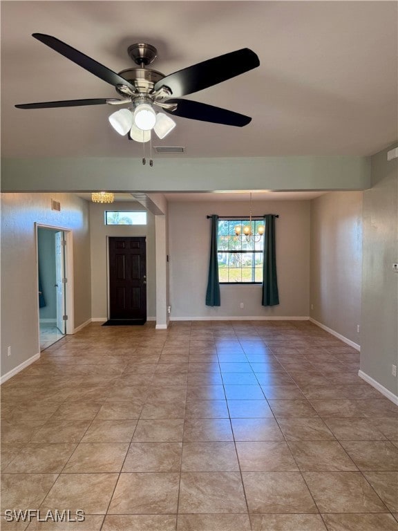 Tiled empty room featuring ceiling fan with notabl