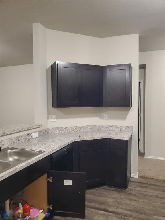 Kitchen with a sink, light countertops, dark cabin