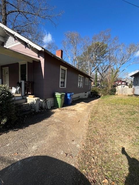 View of side of home featuring a yard