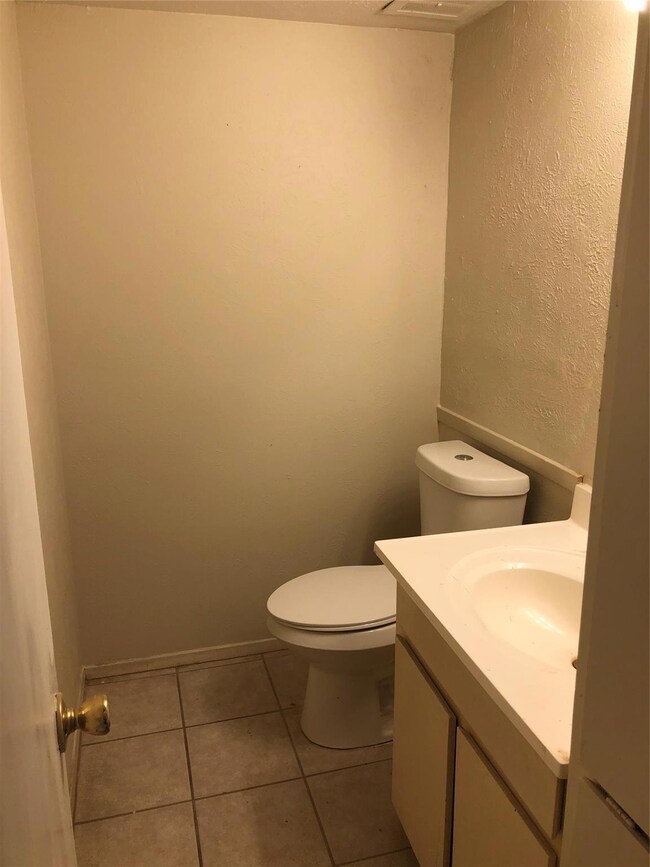 Bathroom featuring vanity, tile patterned flooring