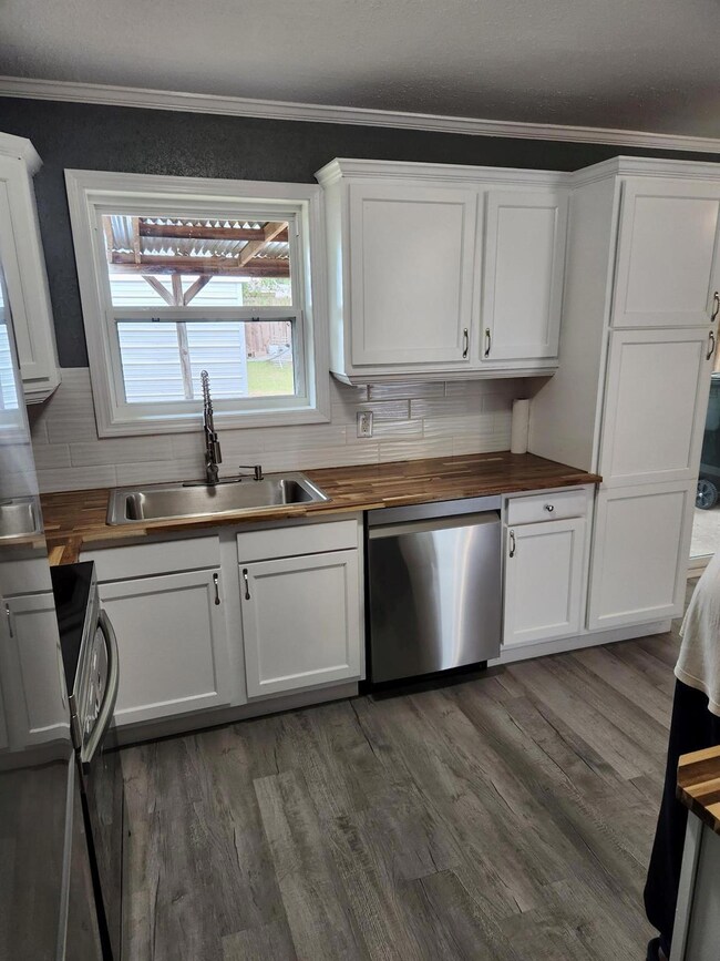 Kitchen with sink, dishwasher, butcher block count