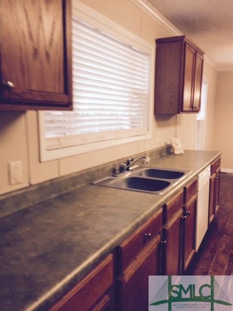 Rear sink wall in kitchen overlooking rear yard wi