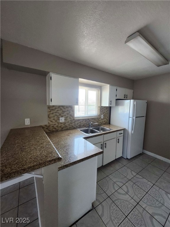 Kitchen featuring freestanding refrigerator, a pen