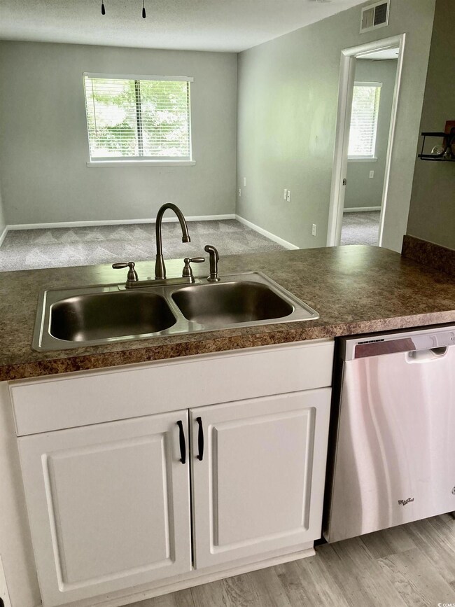 Kitchen with light hardwood / wood-style floors, s