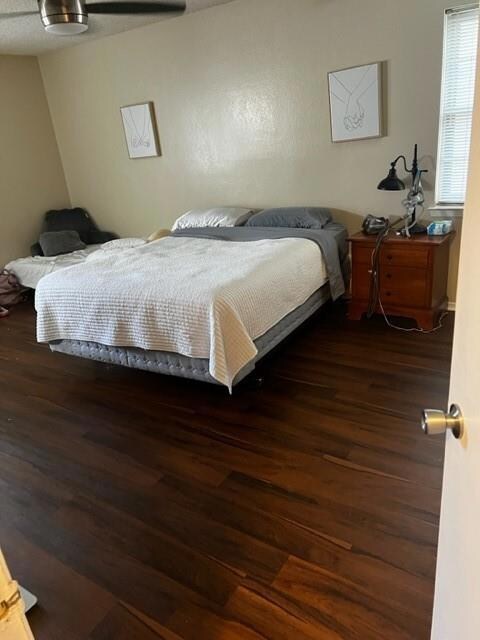 Bedroom featuring ceiling fan and dark hardwood / wood-style flooring