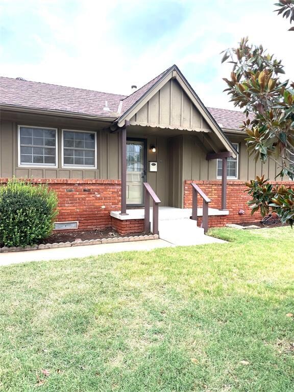 Single story home featuring a patio and a front ya