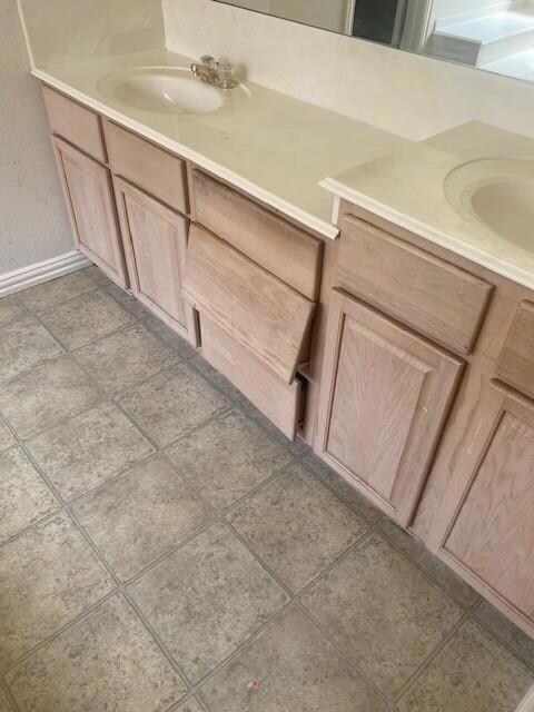 Bathroom featuring vanity and tile patterned flooring