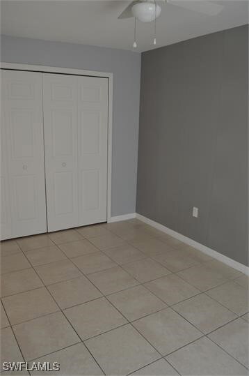 Unfurnished bedroom with a closet, ceiling fan, an