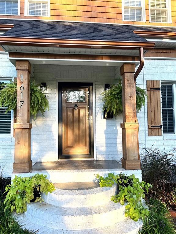 View of exterior entry featuring a porch