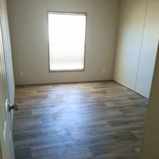 Spare room with wood finished floors