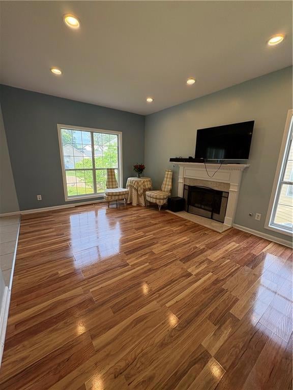 Living area with wood finished floors, recessed li