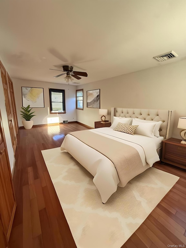 Bedroom with dark wood-style floors and ceiling fan