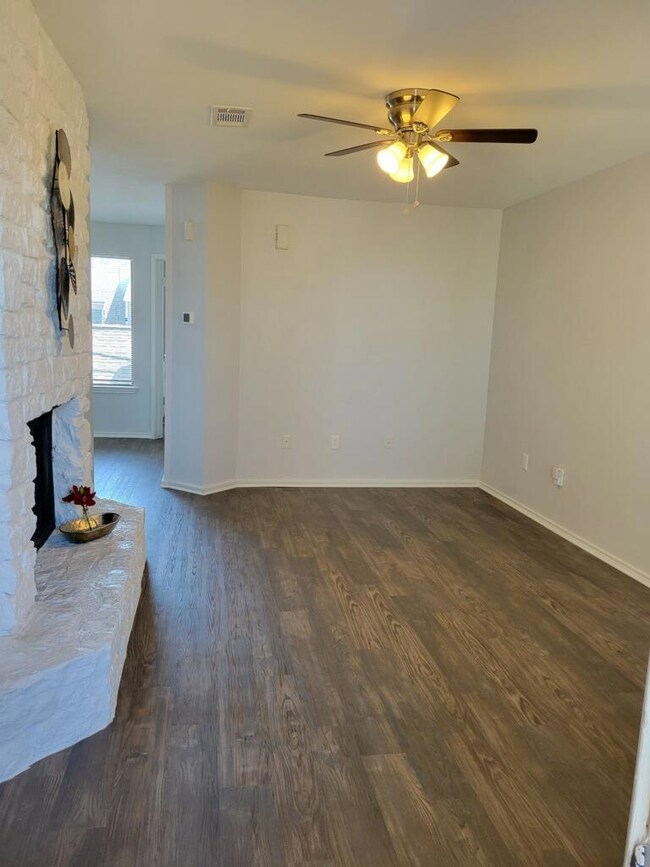 Unfurnished living room featuring dark wood-type 