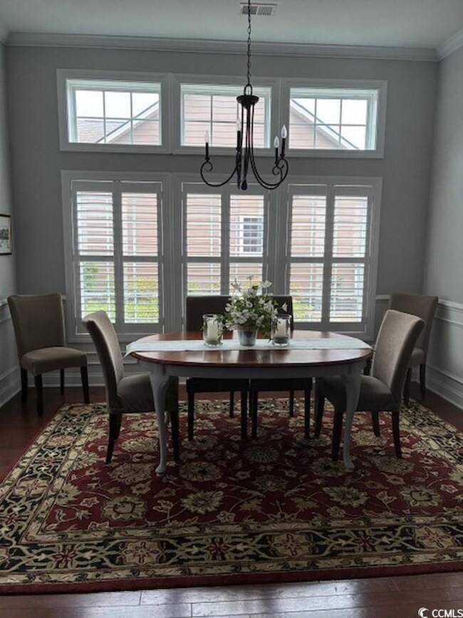 Dining room featuring crown molding, visible vents