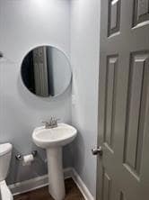 Bathroom featuring baseboards and toilet