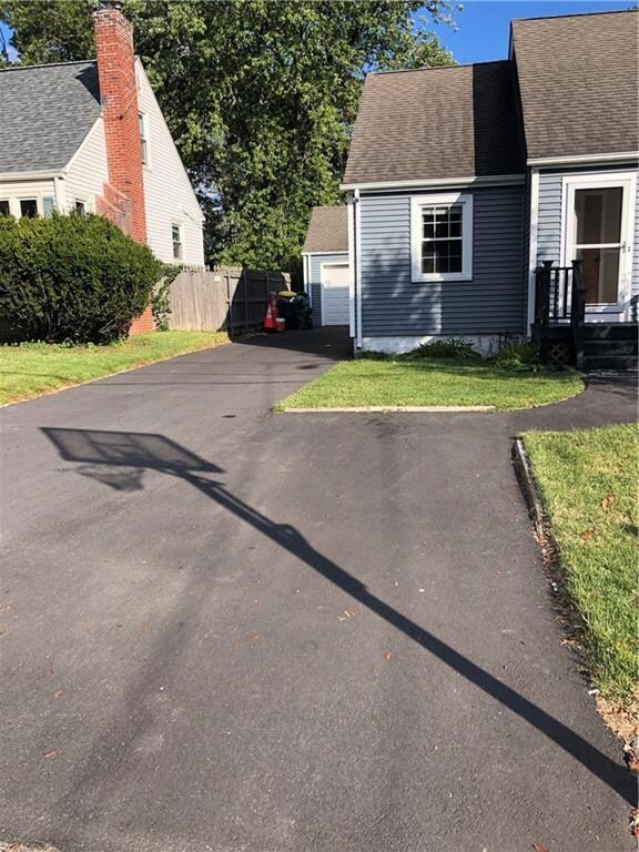 Front view with detached garage in rear left