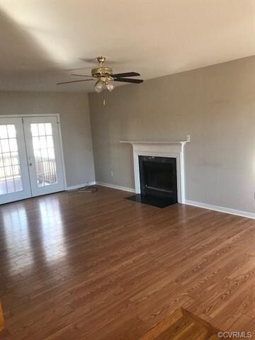 Gorgeous sunken living room with hardwood flooring, fireplace and french doors leading to the rear deck.