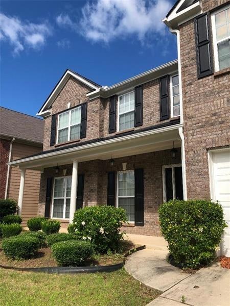 View of front of house featuring brick siding and 