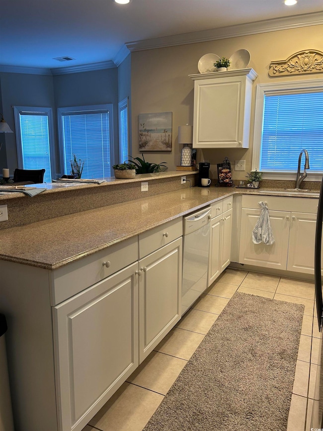 Kitchen featuring white dishwasher, a sink, white 
