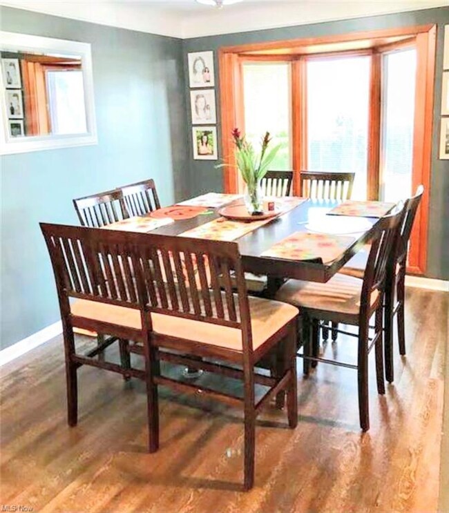 Dining room features gorgeous Pella bay window wit