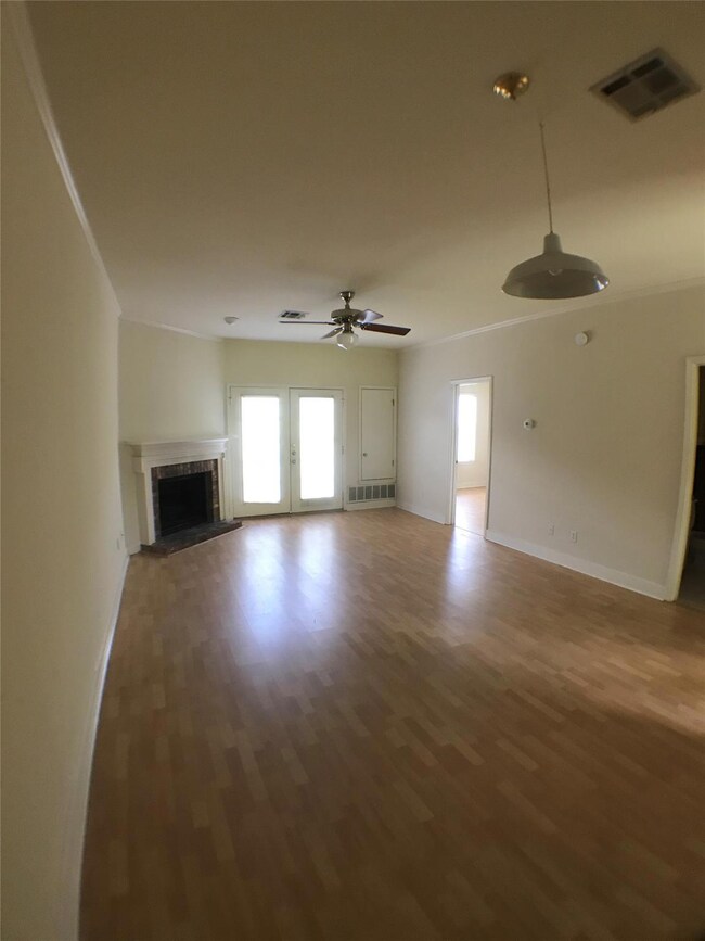 Unfurnished living room featuring wood finished f