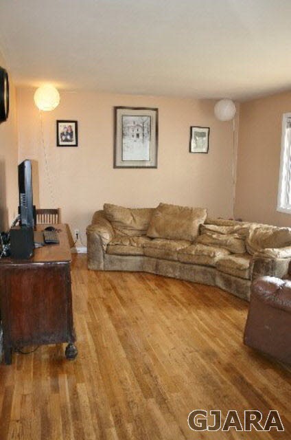 Original hardwood floors warm the room.