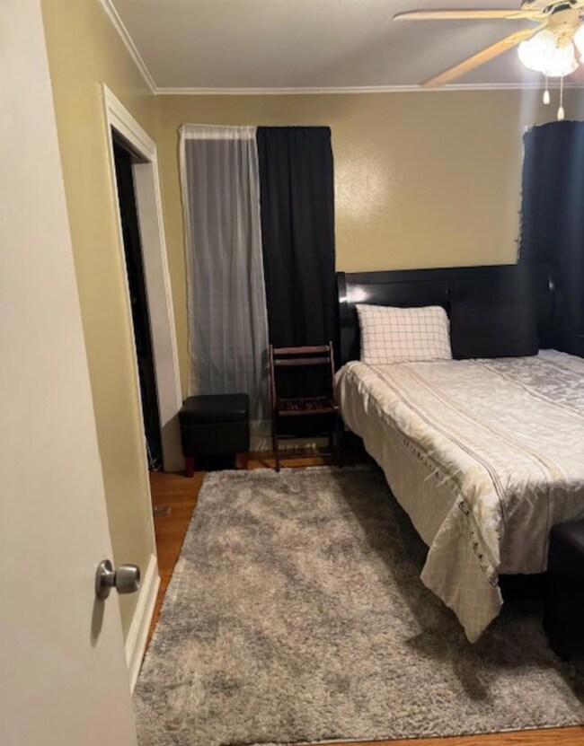 Bedroom with dark hardwood / wood-style flooring, 