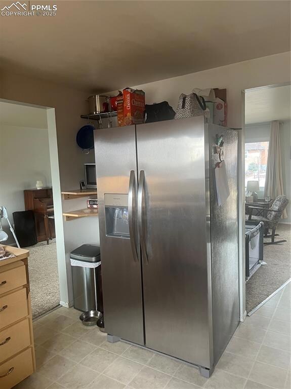 Kitchen with stainless steel refrigerator with ice