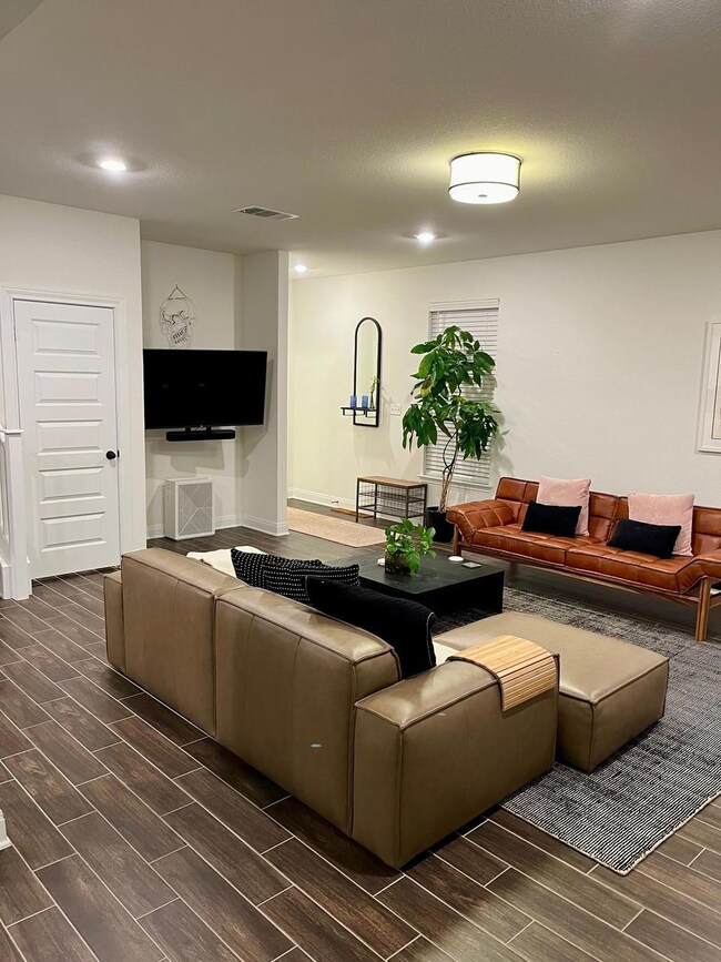 Living room with wood tiled floors and recessed l
