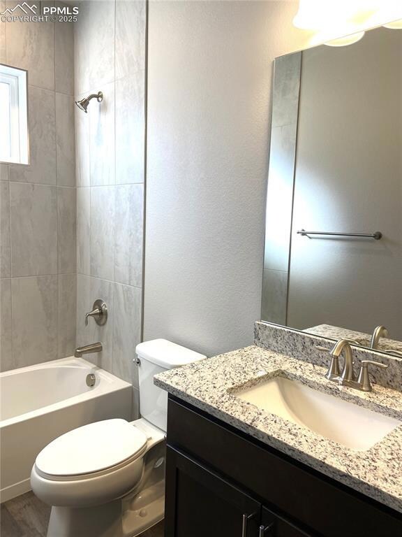 Full bathroom featuring hardwood / wood-style floo
