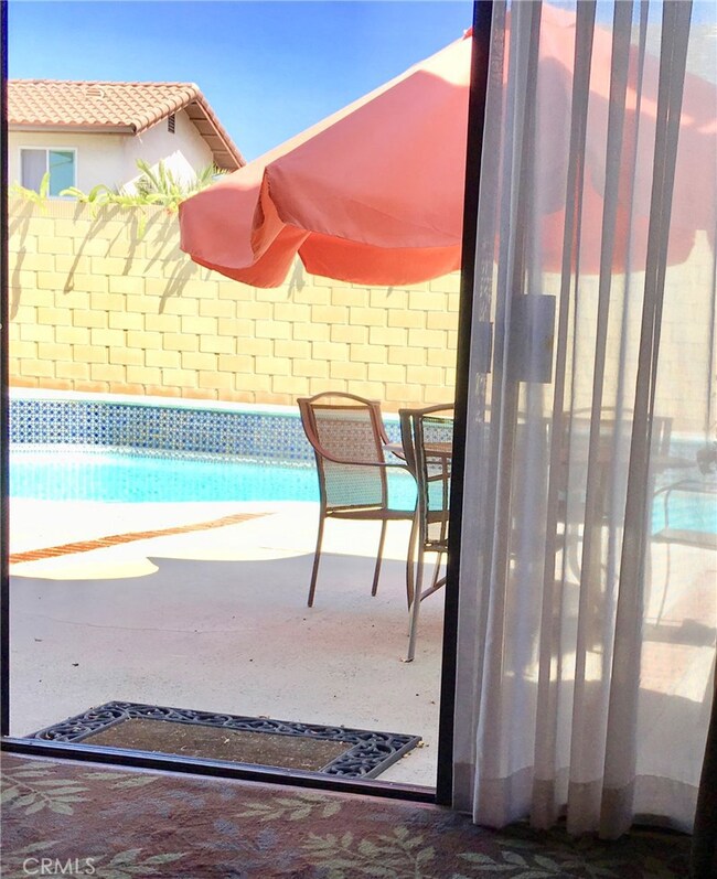 View from den thru sliding doors to pool.