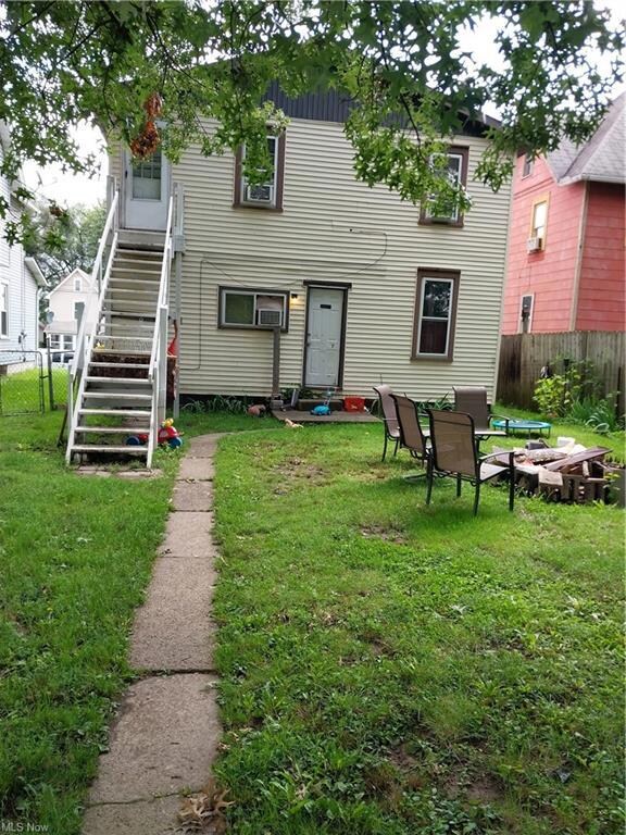 Rear view of house with a lawn